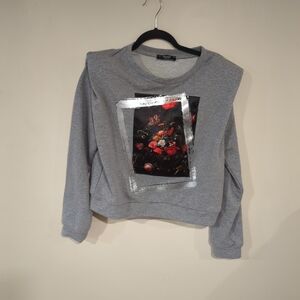 Gray sweater with floral graphic.